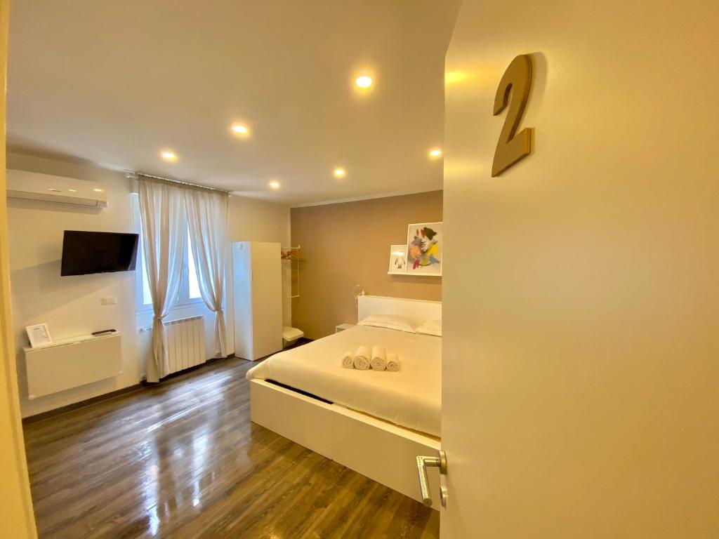 Posteľ alebo postele v izbe v ubytovaní Mimì Rooms&Studios