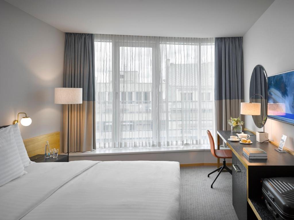 Postel nebo postele na pokoji v ubytování K+K Hotel Fenix