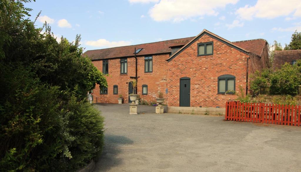 a brick building with a driveway in front of it at 1 Fox Studios in Much Wenlock