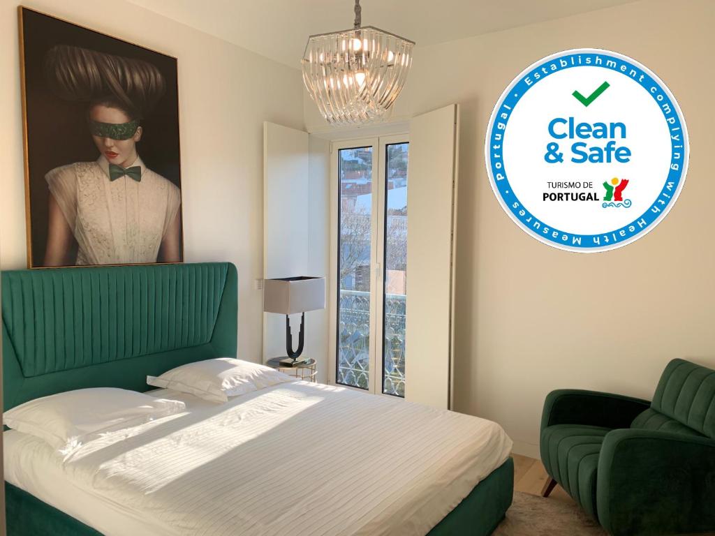 a bedroom with a bed and a poster of a man in a suit at New!! Luxury Avenida Da Liberdade Flat- with Rooftop and Pool in Lisbon