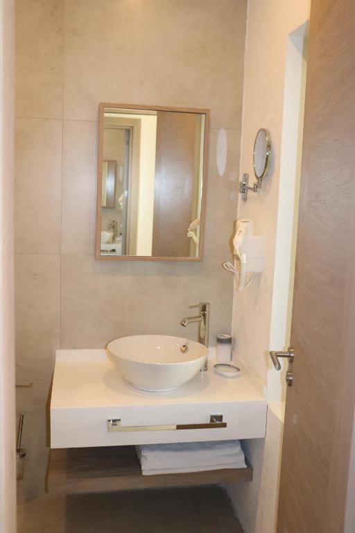 a bathroom with a white sink and a mirror at Zest Exclusive Hotel & Spa in Ortakent