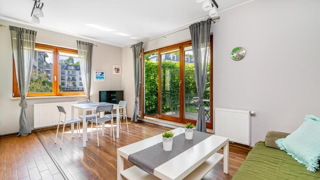 a living room with a couch and a table at Aquarius Sopot - BillBerry Apartments in Sopot