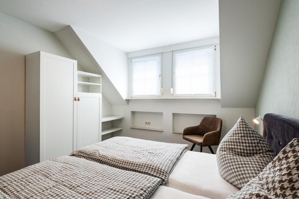 Postel nebo postele na pokoji v ubytování Moselweingut & Gästehaus Hubertushof
