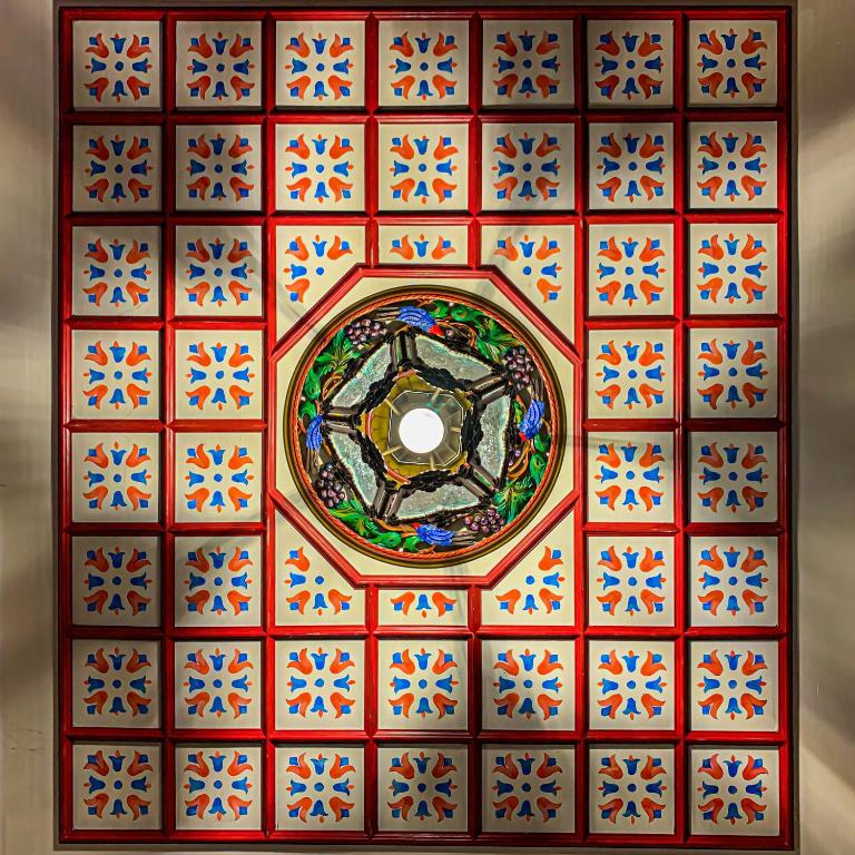 a colorful tile ceiling with a circle in the middle at ARCHONTARIKI Historic Boutique Hotel in Ioannina