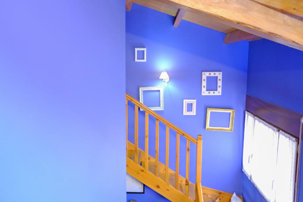 a blue room with a staircase and a blue wall at Vallespin Suite in Ávila