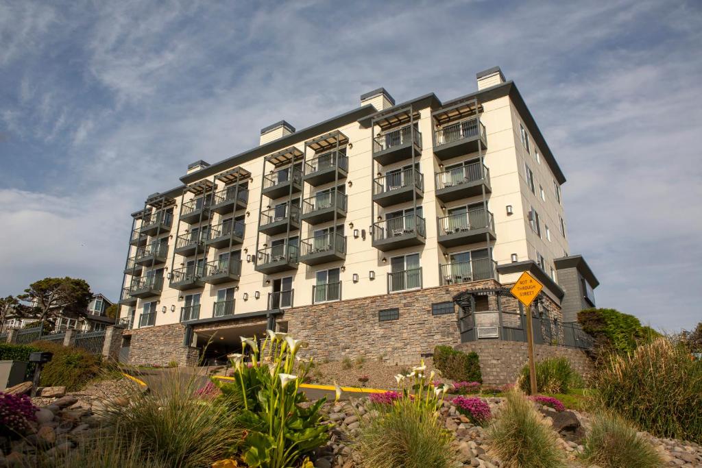 um grande edifício branco com flores em frente em Shearwater Inn em Lincoln City