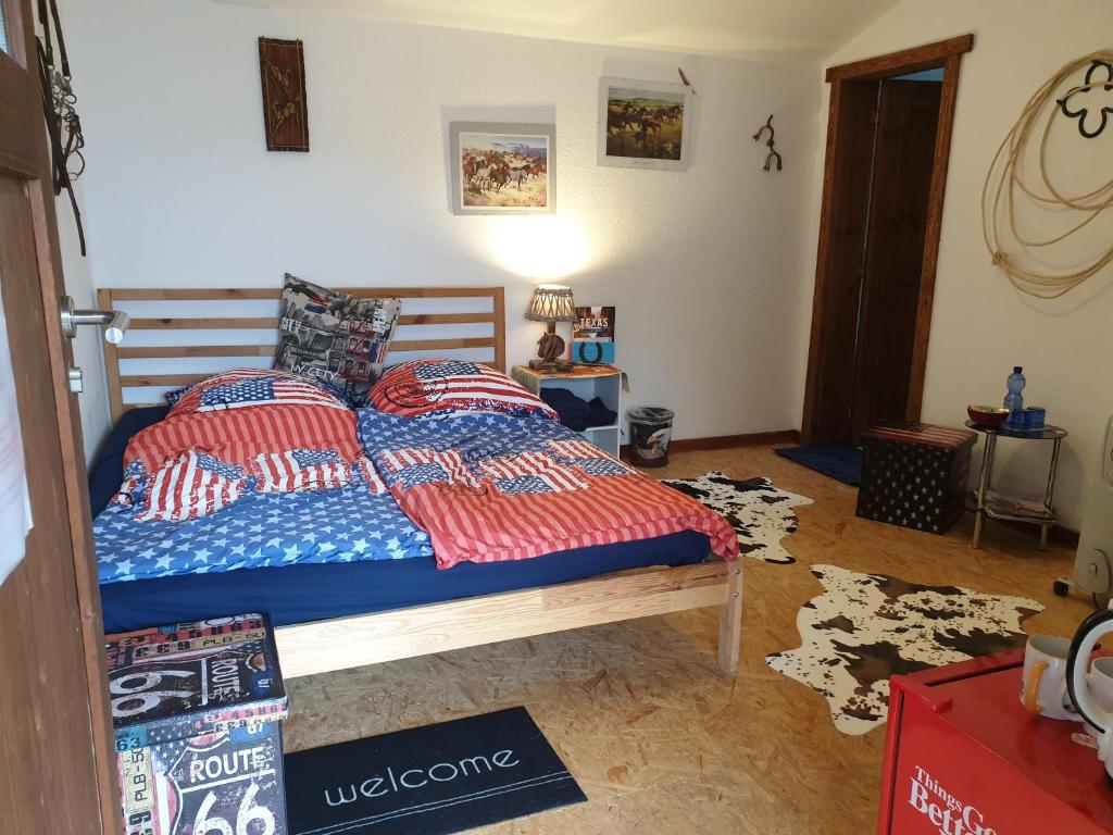 a bedroom with a bed with two pillows on it at Chrom Ranch Reiterhof in Memmingen