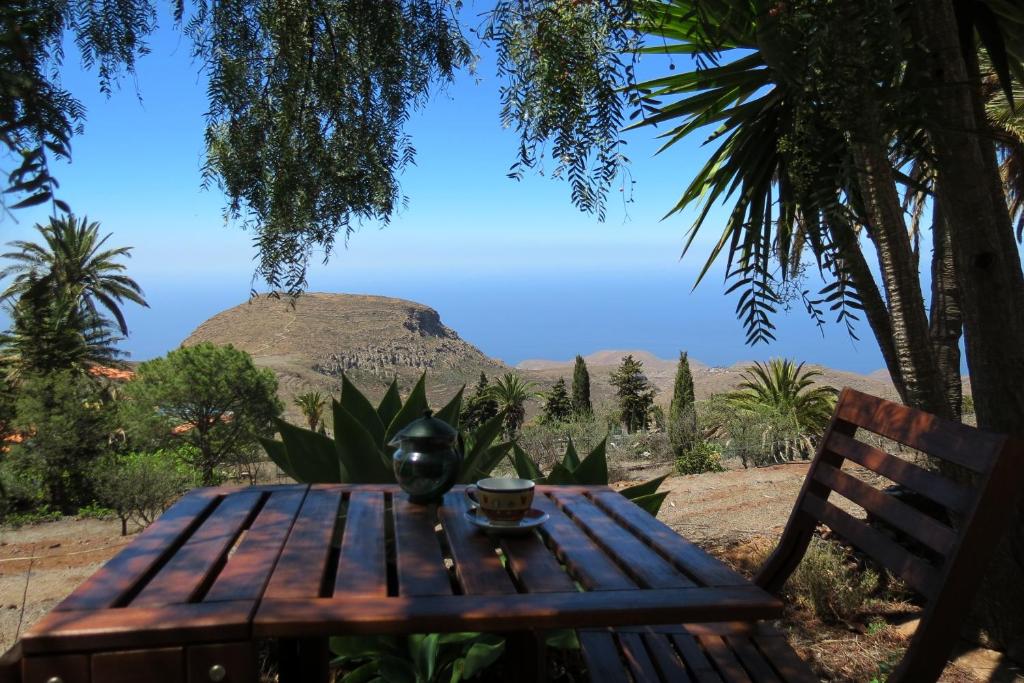 a wooden table with a vase sitting on top of it at Vista del Sur in Alajeró