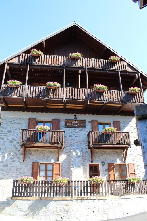 a building with balconies and potted plants on it at Chalet La Fedora - Appartements de charme in Vaujany