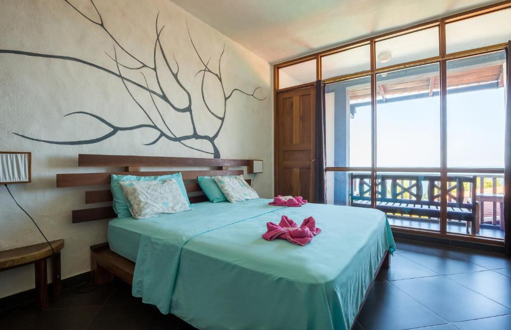Postel nebo postele na pokoji v ubytování Punta Duarte Garden Inn