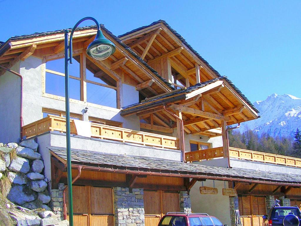 a large house with a balcony on top of it at Modern chalet just 350 m from the ski lifts in Peisey-Nancroix