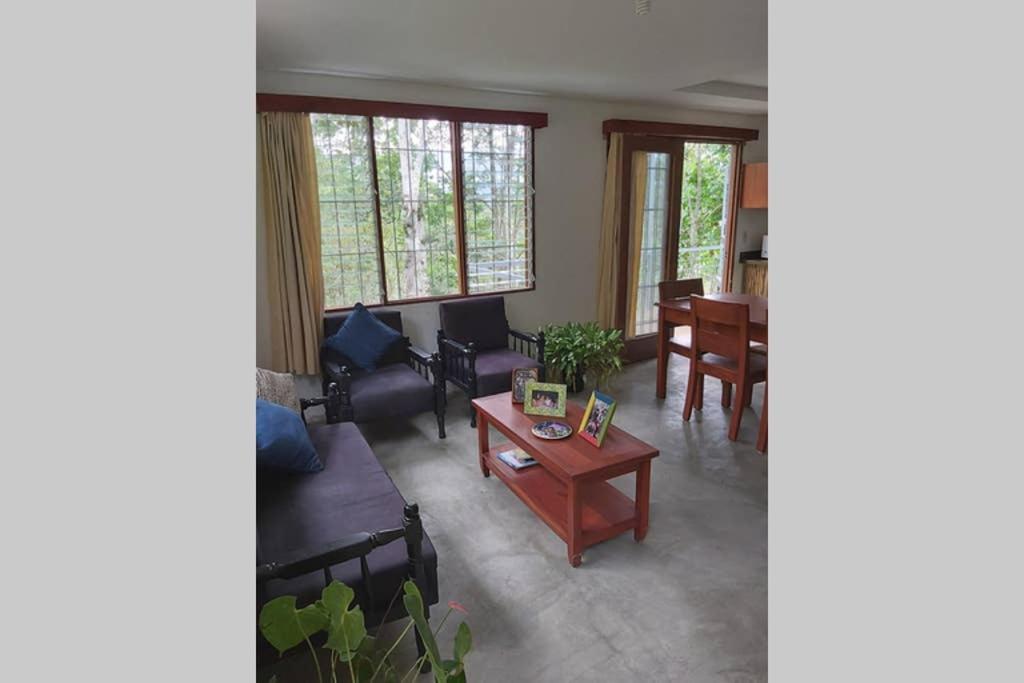 a living room with a couch and a table at The Calm House in Turrialba