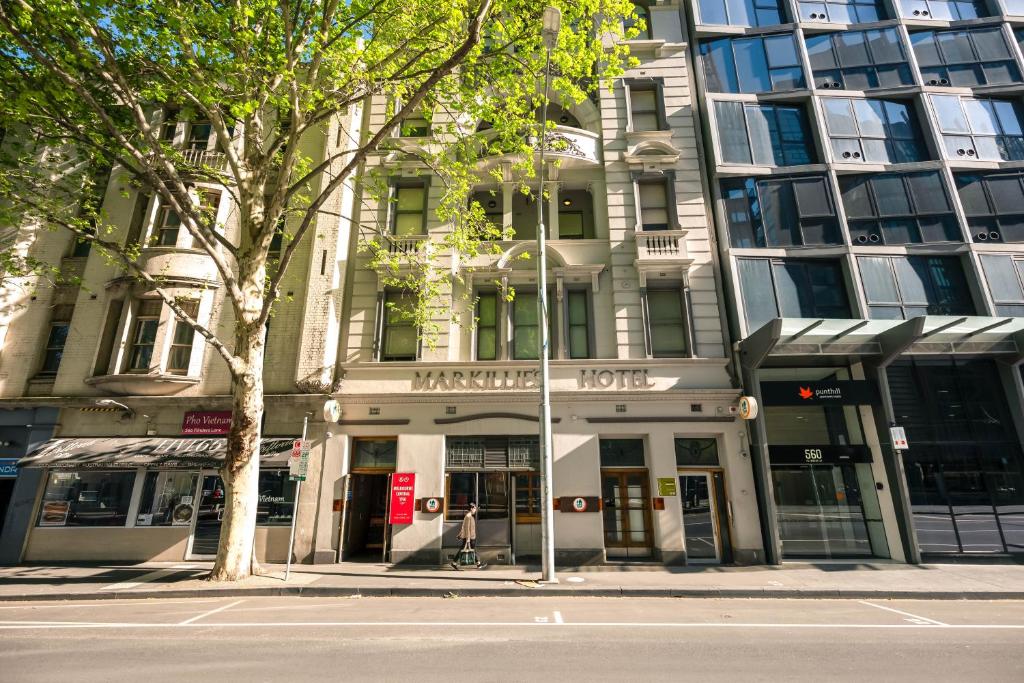 a building on the corner of a city street at YHA Melbourne Central in Melbourne