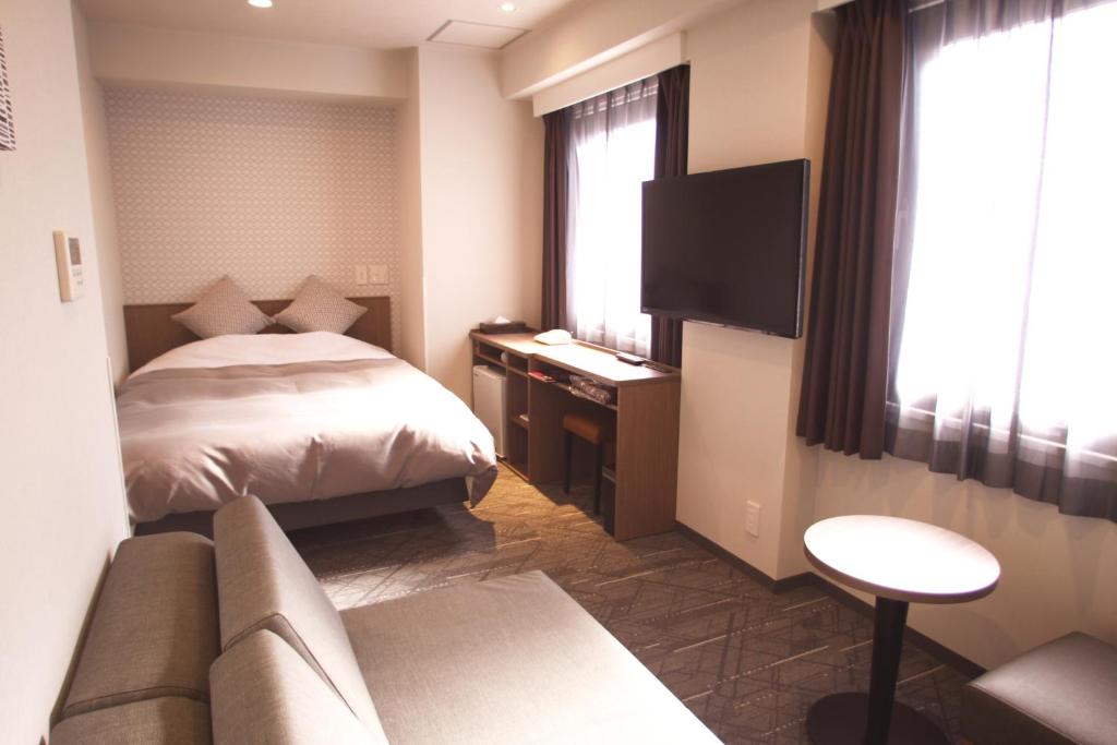 Кровать или кровати в номере Hotel Sun Royal Utsunomiya