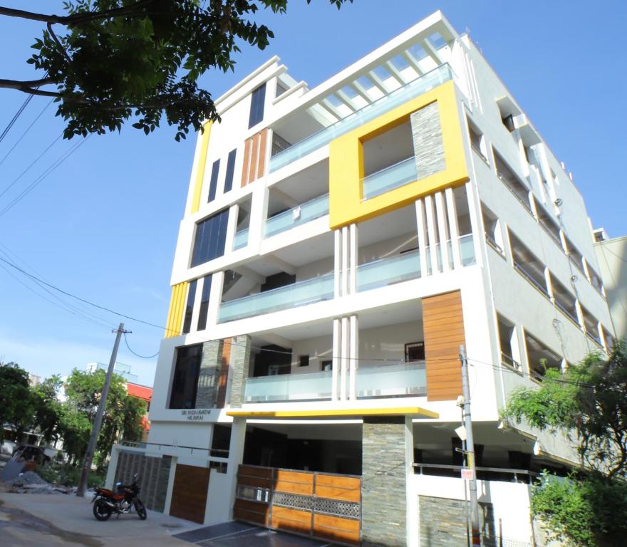 a building with colorful balconies on a street at TrueLife Homestays - Royal Nagar -Near Railway Station on way to Balaji Temple - Best Location - Mountain View - Fully Furnished 2BHK AC Apartments for Family Stay - Modular Kitchen, Fast WiFi, Android TV - 250 Jio Channels - Top Service with lots of Love in Tirupati