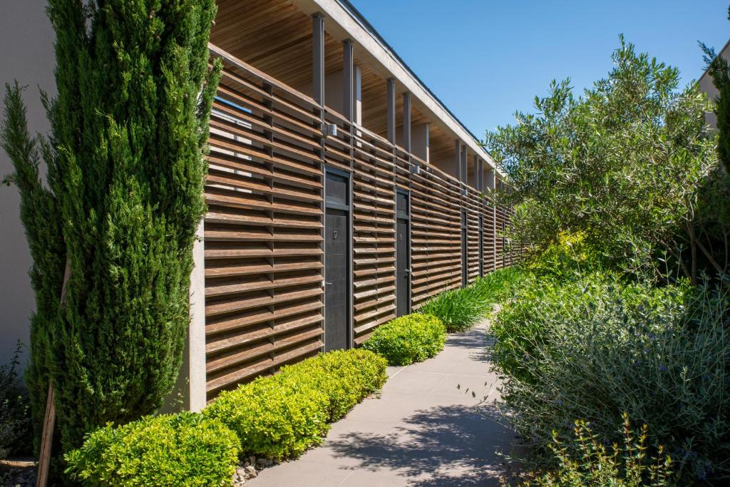 a building with a walkway in front of it at Costa Nera Beach House in Porto-Vecchio