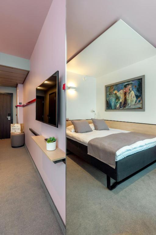 Voodi või voodid majutusasutuse Art Hotel Pallas by Tartuhotels toas