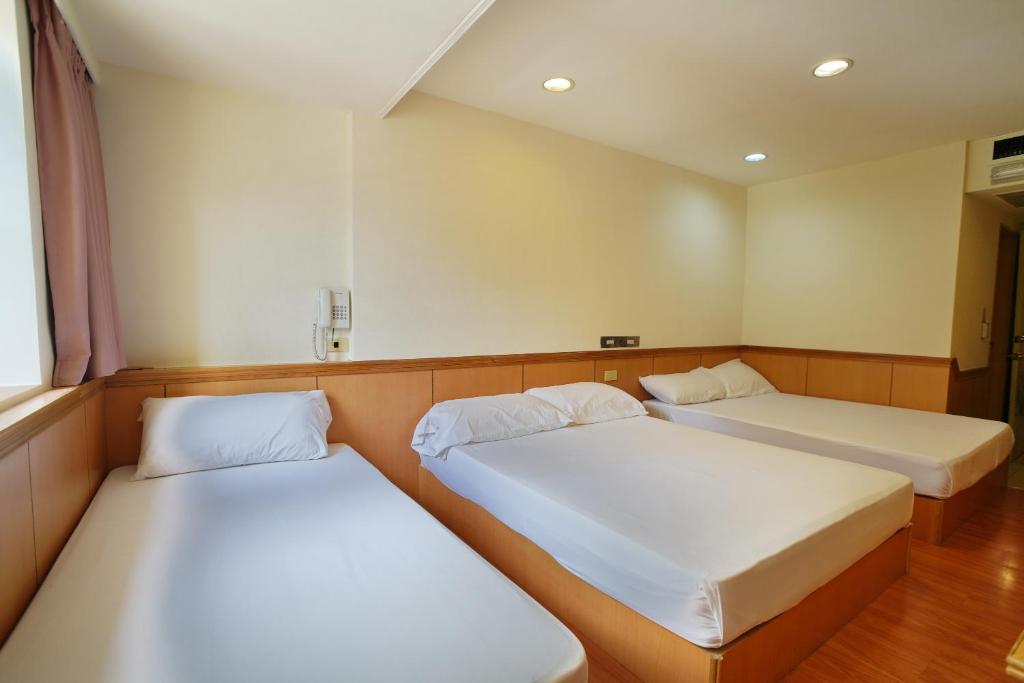 Postel nebo postele na pokoji v ubytování Wun Sun Hotel