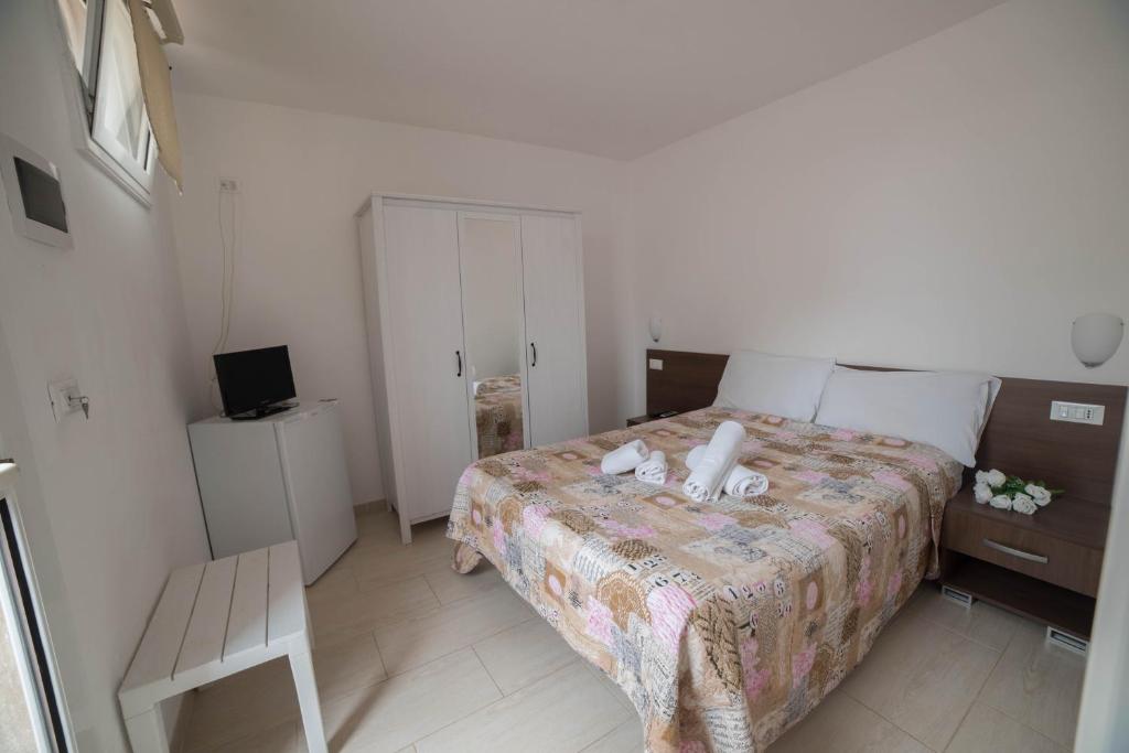 a small bedroom with a bed and a chair at Villa Lara in Polignano a Mare