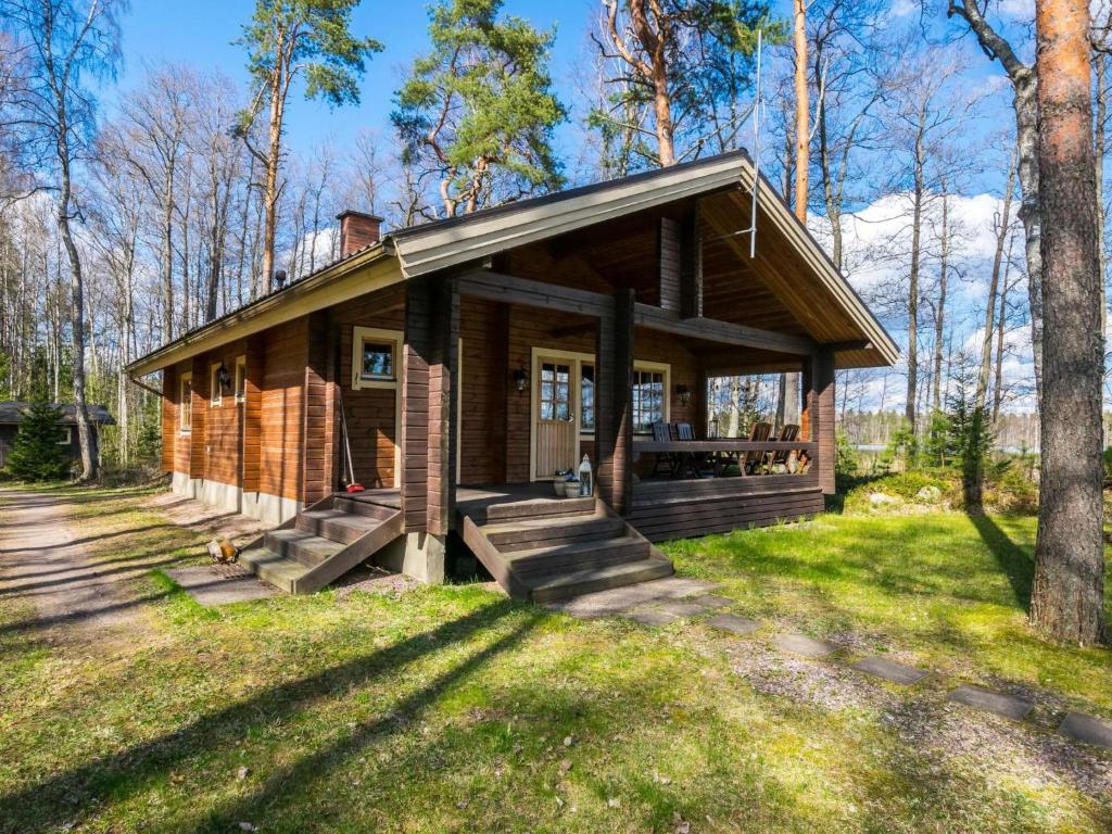 une cabane dans les bois avec un chien devant elle dans l'établissement Holiday Home Lammassaari by Interhome, à Somerniemi