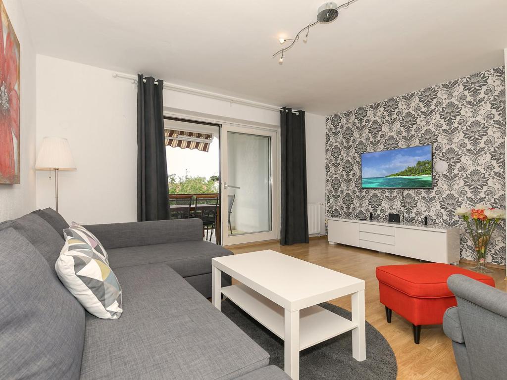 a living room with a couch and a table at Apartments Špadići in Poreč