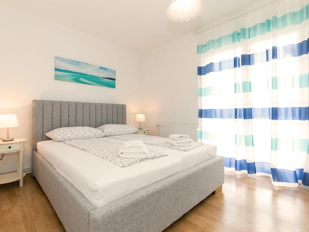 a bedroom with a bed and a window at Apartments Špadići in Poreč