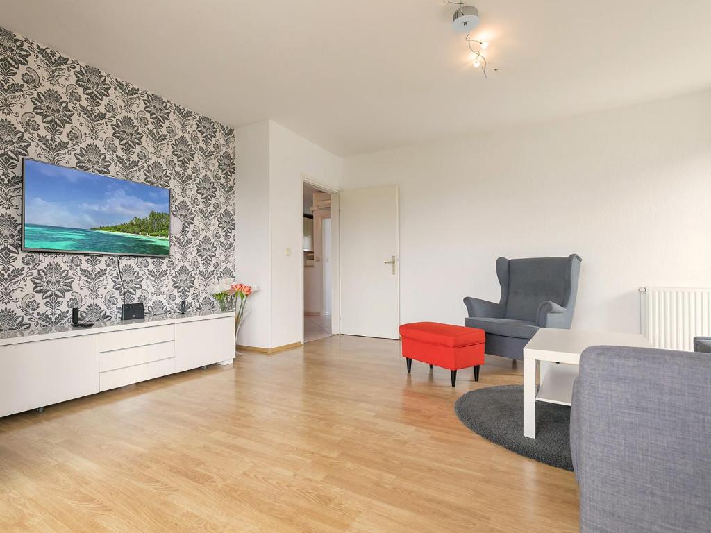 a living room with a table and a chair at Apartments Špadići in Poreč