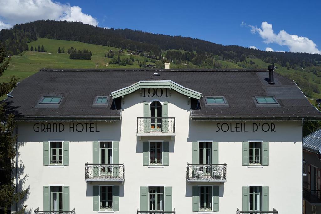 a large white building with the words grand hotel and soldowment at Grand Hotel Soleil d'Or in Megève