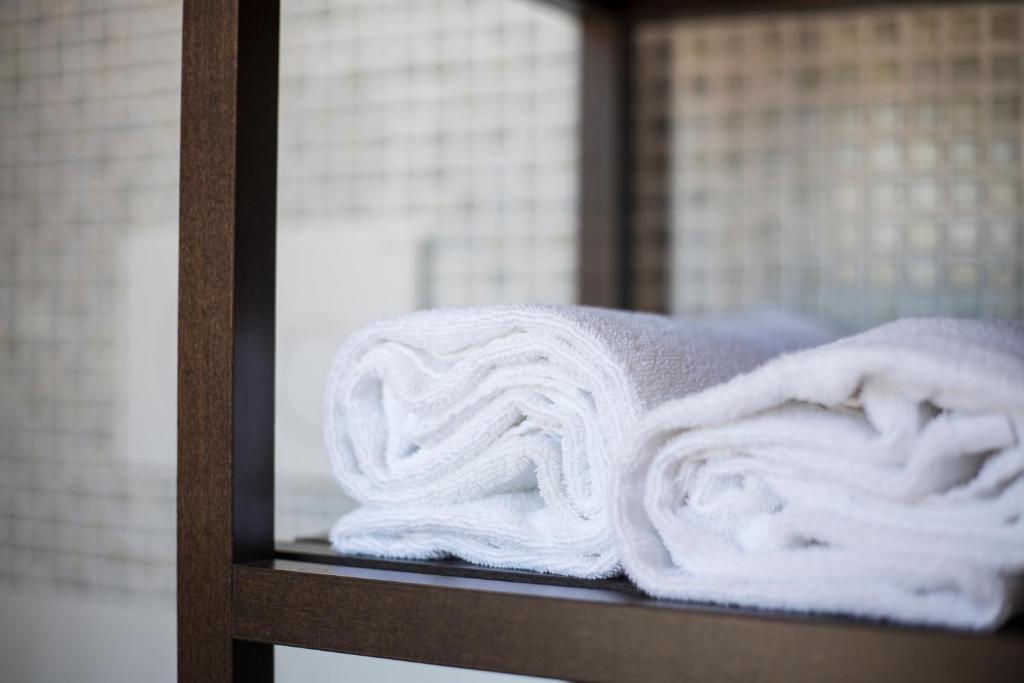 a pile of towels sitting on a shelf at Villa Lara in Polignano a Mare