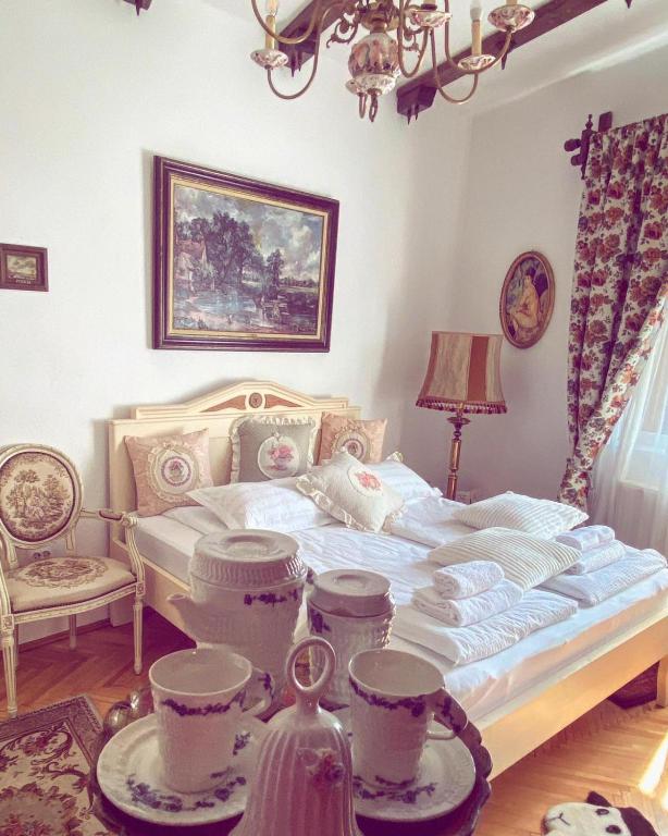 a bedroom with a bed with dishes on it at Casa Rosca in Sighişoara