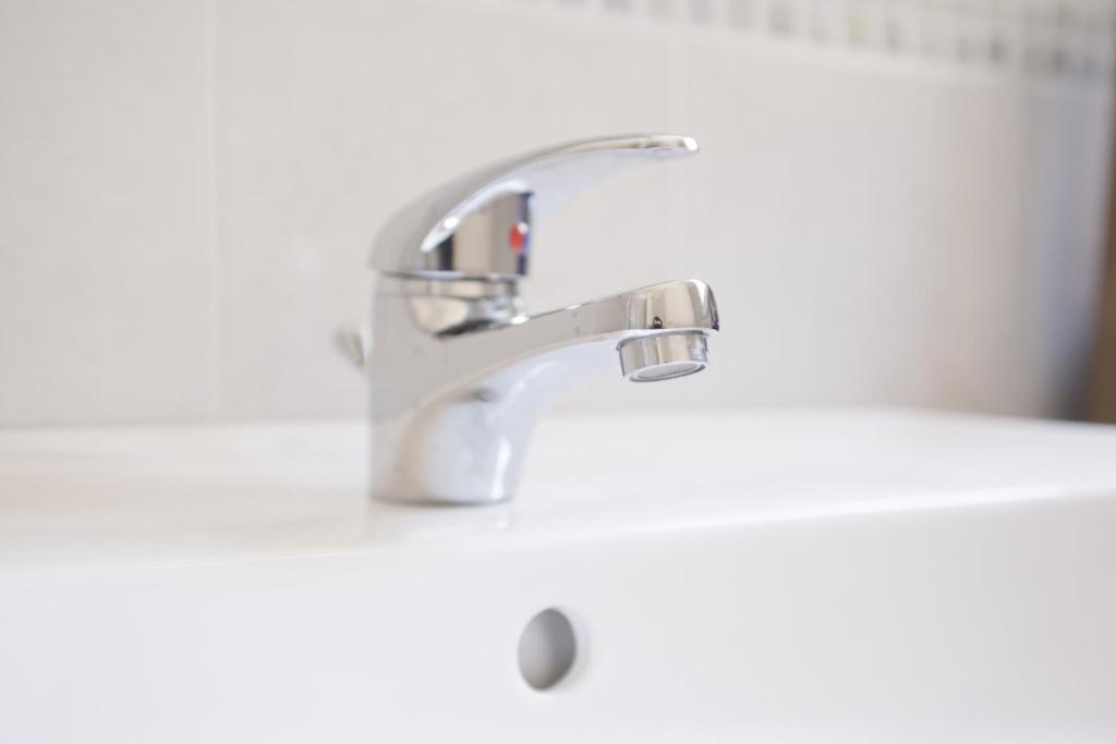 a bathroom sink with a silver faucet at Villa Lara in Polignano a Mare