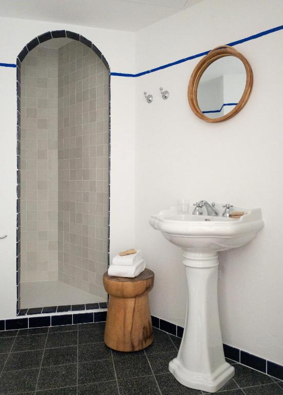 a bathroom with a sink and a shower at Hôtel Le Sud in Juan-les-Pins