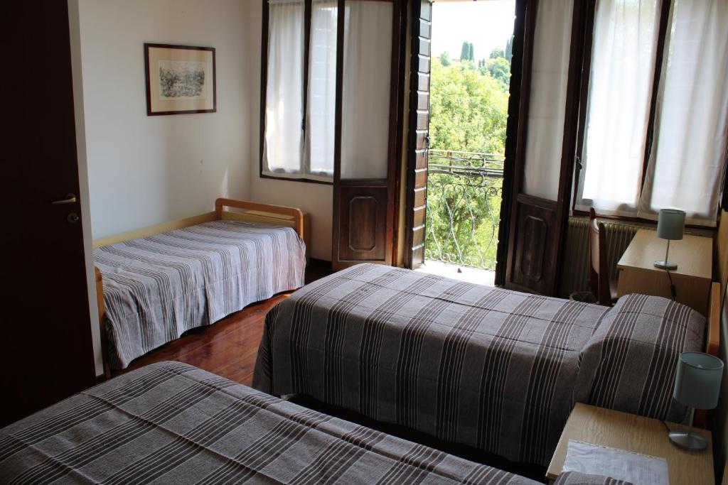 Postel nebo postele na pokoji v ubytování Villa Flangini