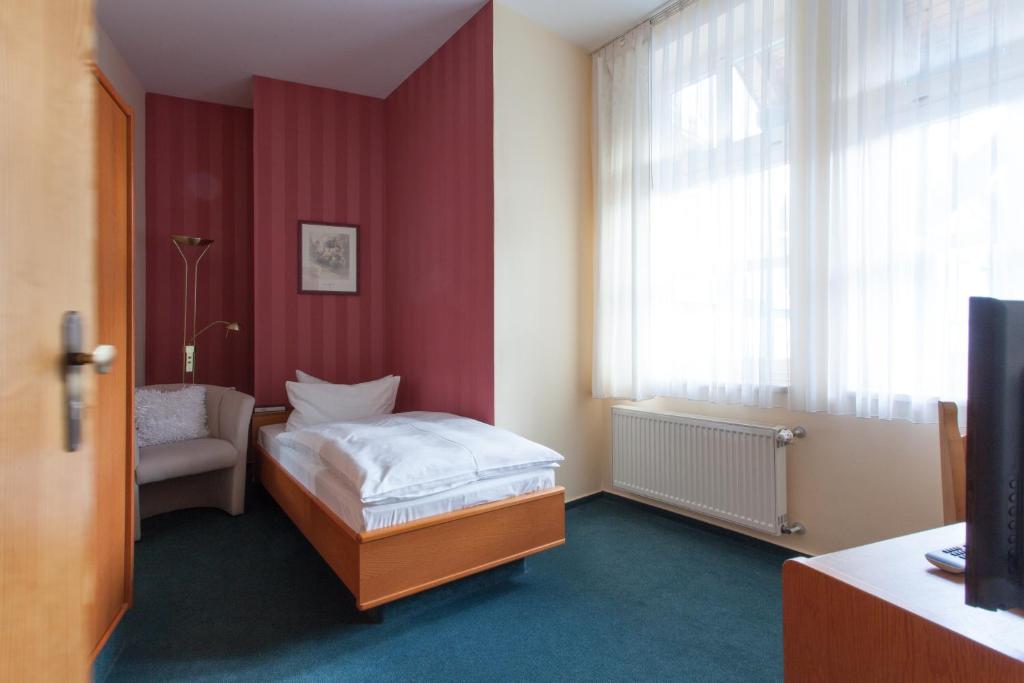 Postel nebo postele na pokoji v ubytování Hotel Am Grudenberg