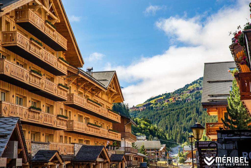 a building with balconies on the side of it at Hotel La Chaudanne in M&eacute;ribel