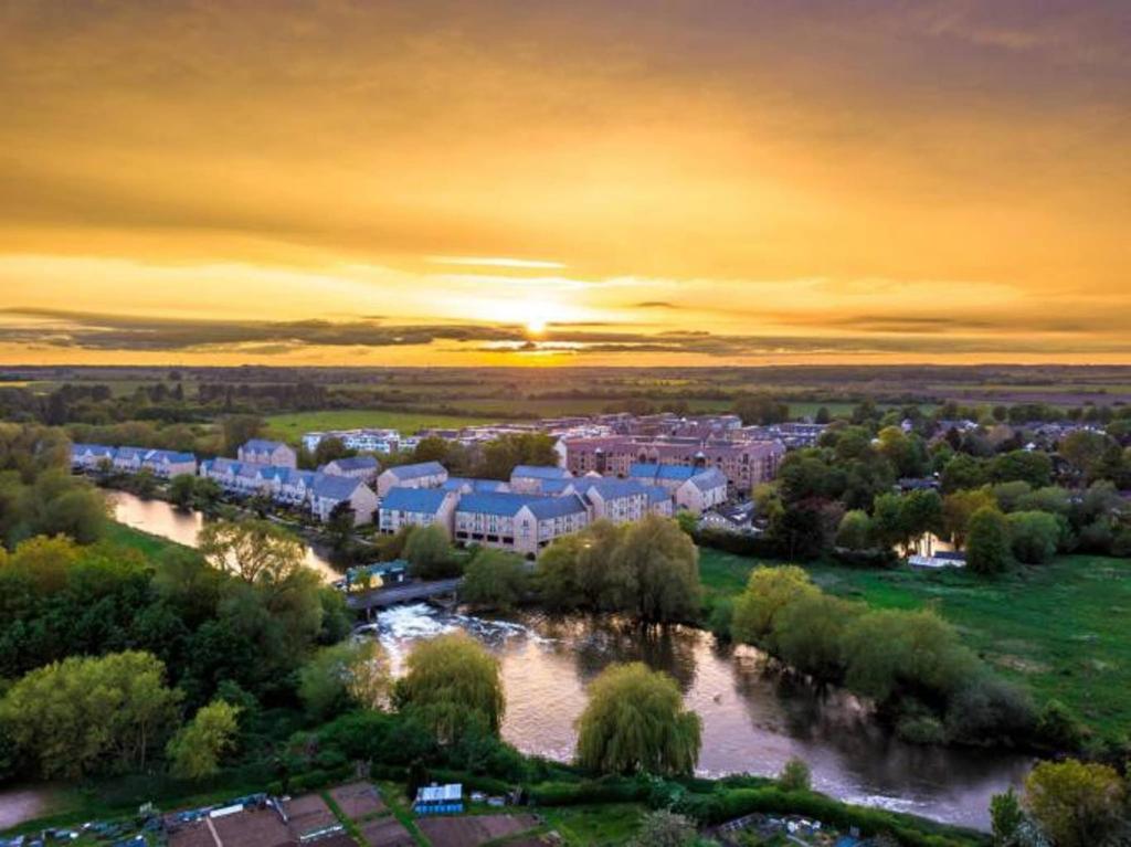 an aerial view of a city with a river at Penthouse Apartment Little Paxton - 47 Skipper Way in Saint Neots