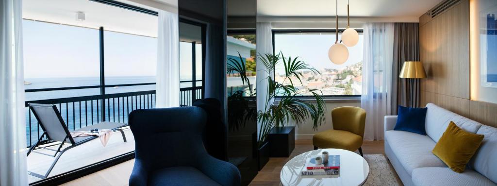 a living room with a view of the ocean at Hotel Excelsior in Dubrovnik