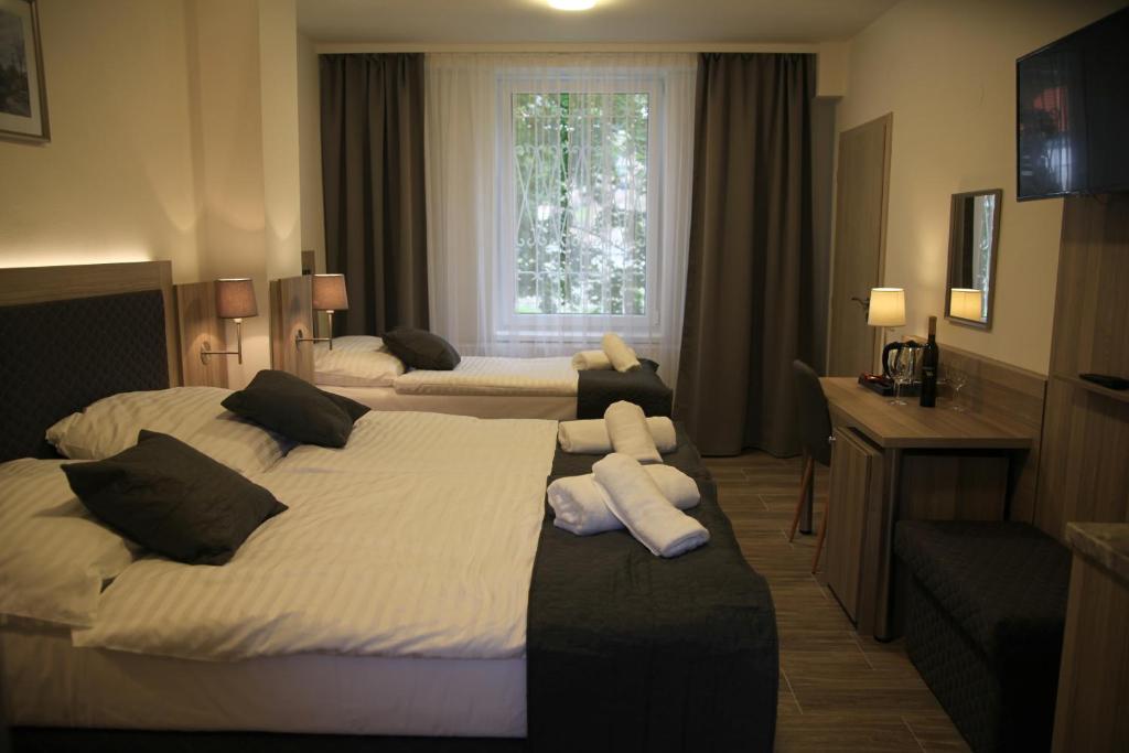 Postel nebo postele na pokoji v ubytování Hotel CK Park