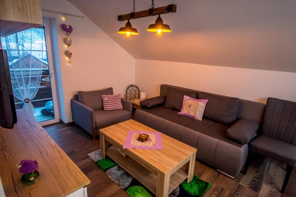 a living room with a couch and a table at Apartmán Levander in Terchová