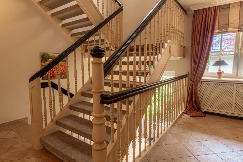 a spiral staircase in a home with a window at Strandhotel Fontana in Timmendorfer Strand