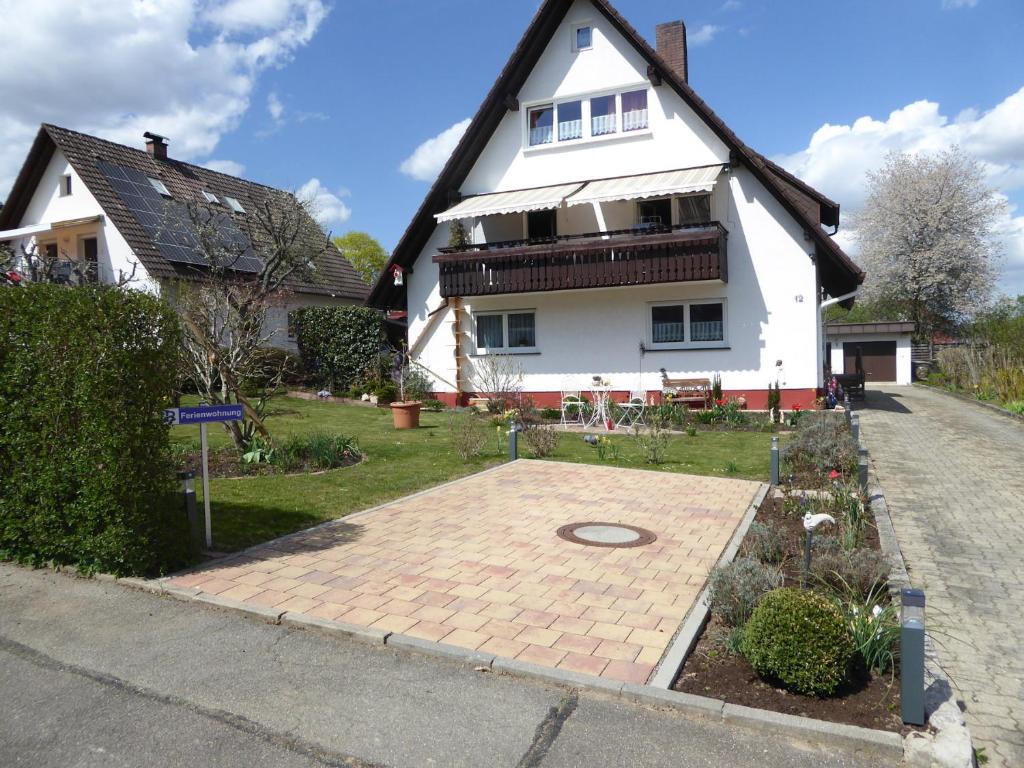 a large white house with a brick driveway in front of it at Ferienwohnung Lemke in Donaueschingen