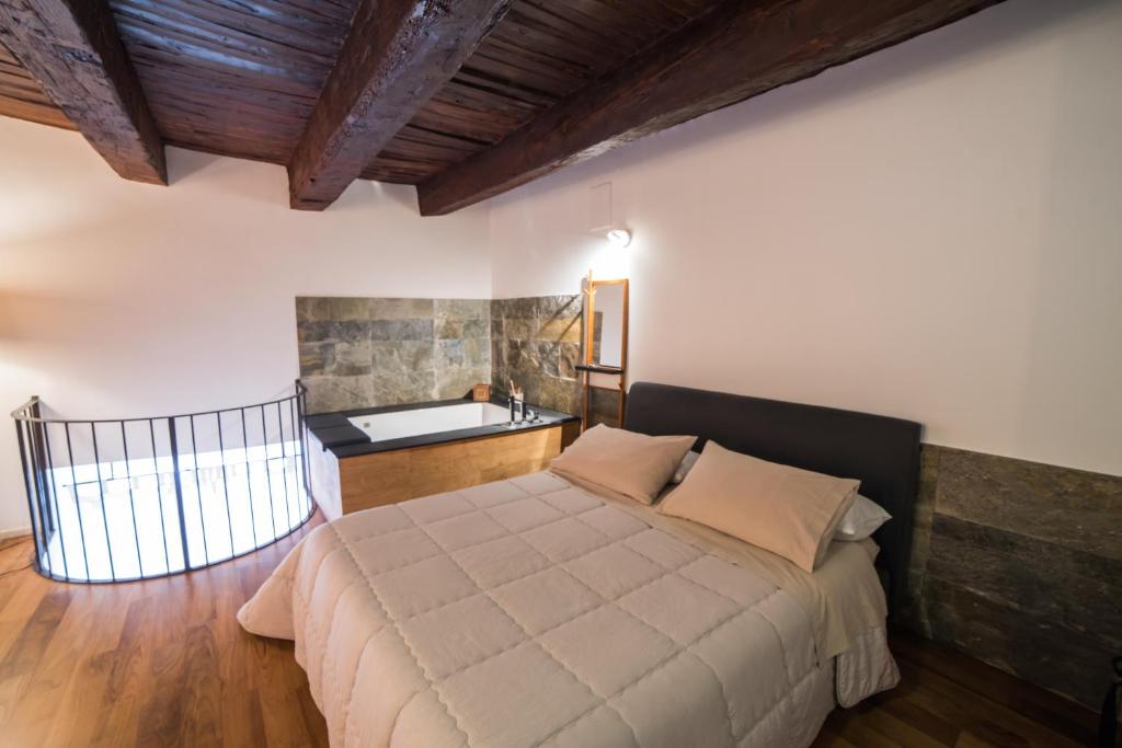 a bedroom with a large bed and a bath tub at Corte Capomazza Appartamenti in Naples