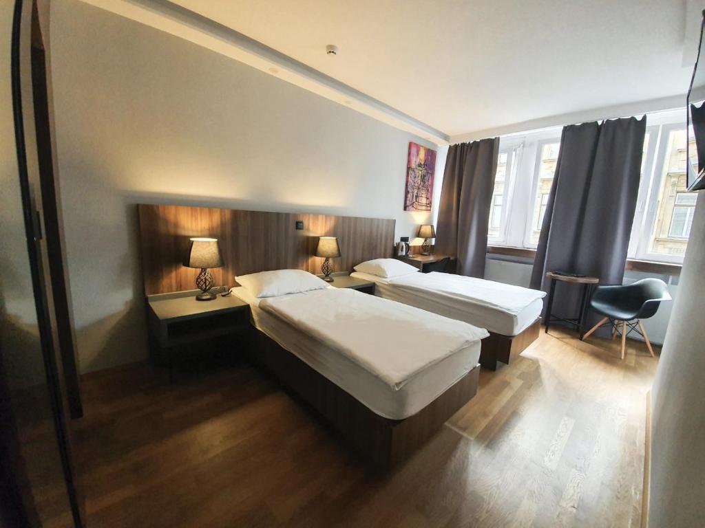 Postelja oz. postelje v sobi nastanitve Atelier Hotel