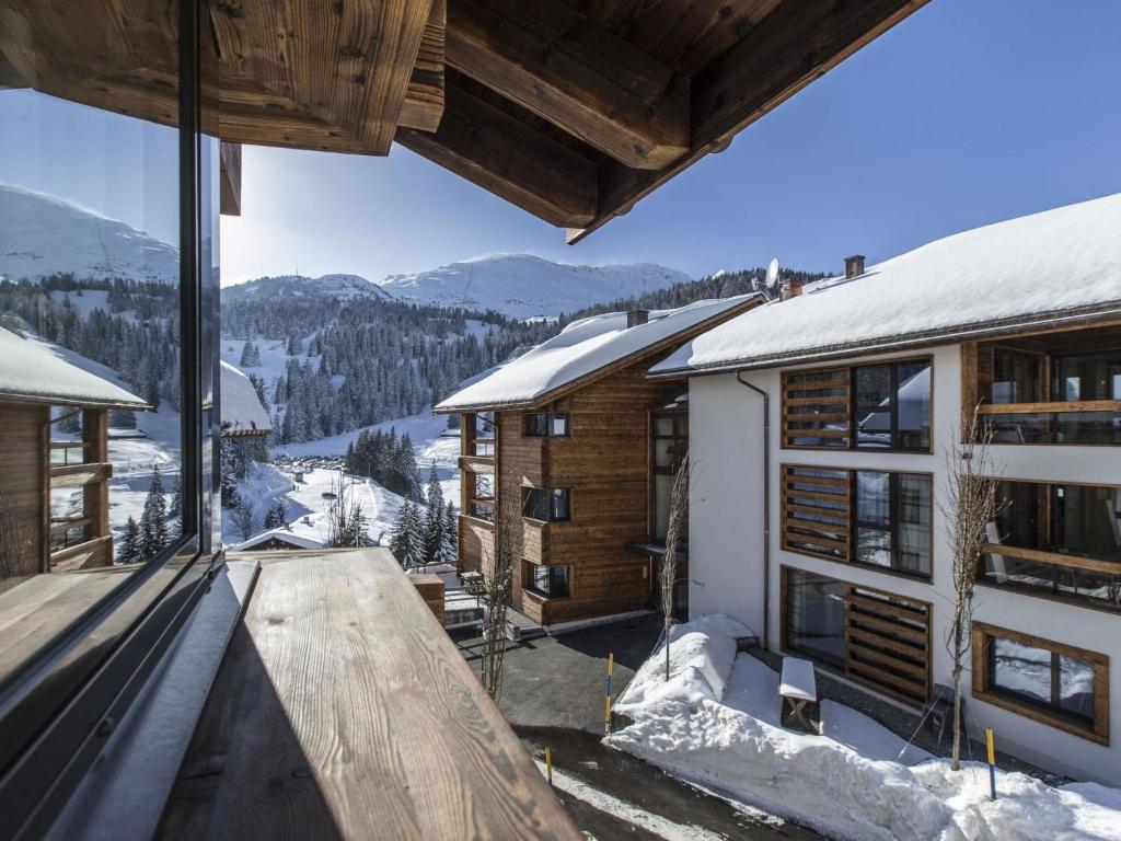 a view from the balcony of a house in the snow at Apartment Turrabuel 4-Bett Deluxe by Interhome in Parpan
