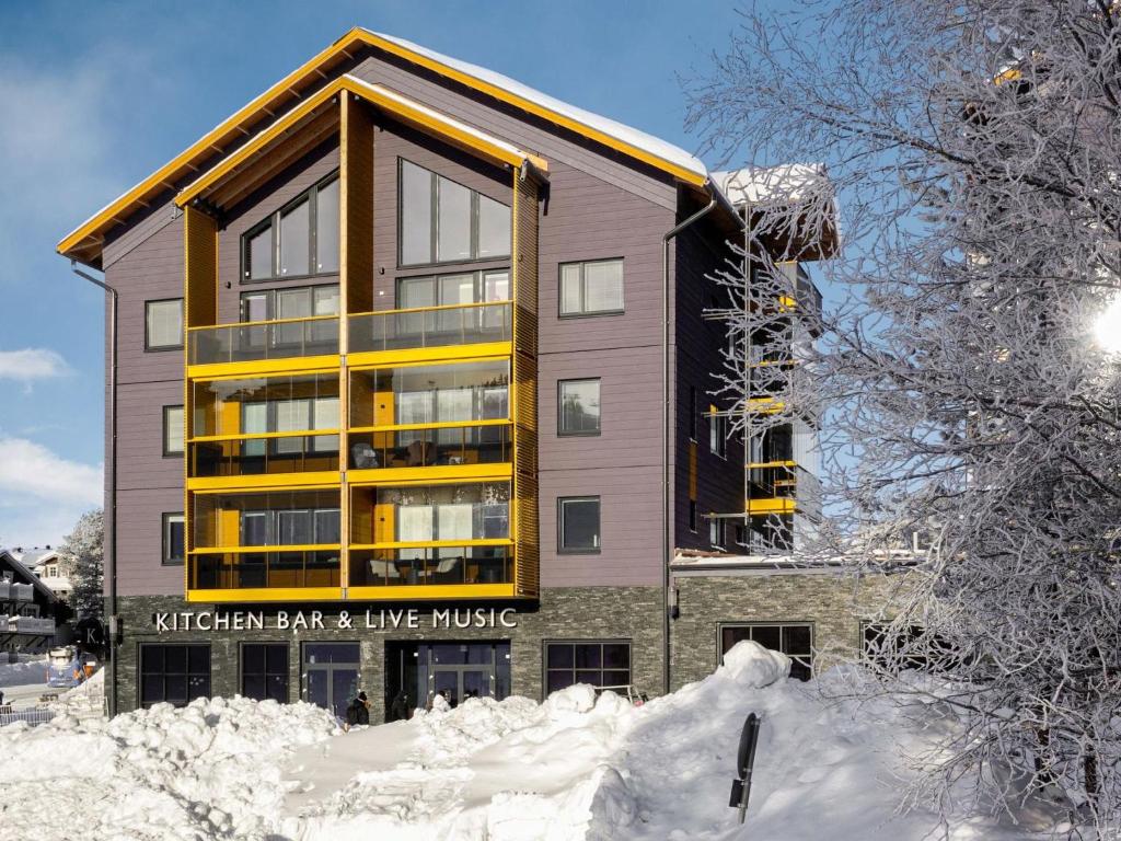 a building with snow in front of it at Holiday Home Levin kunkku b8 by Interhome in Sirkka