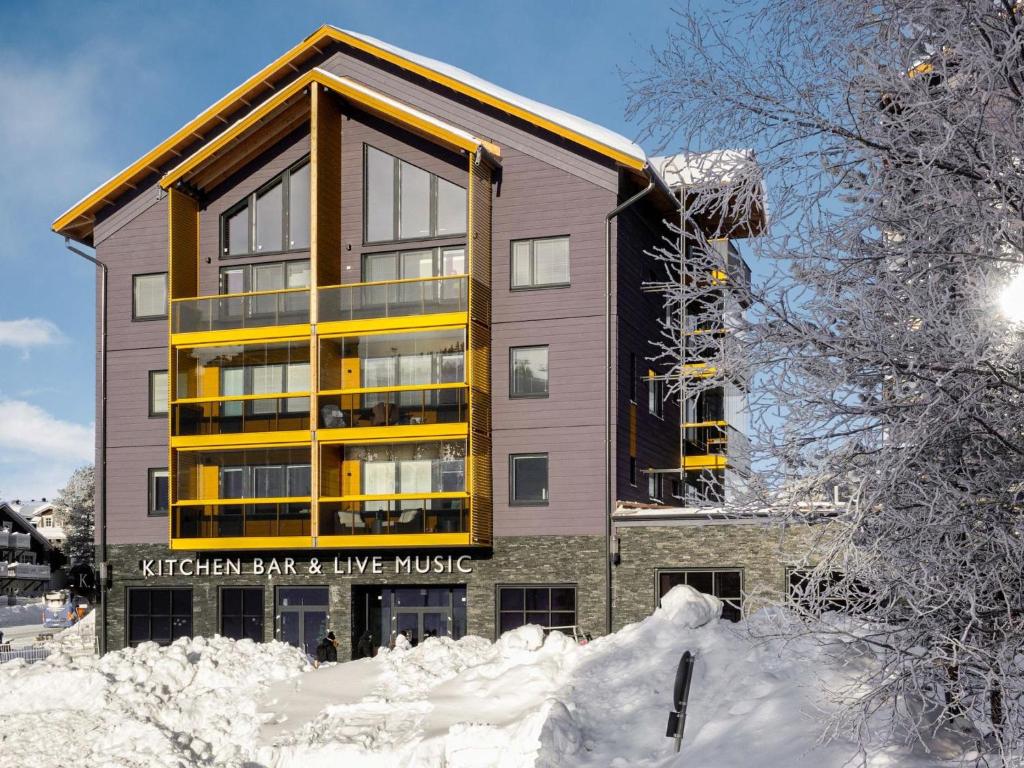 a building with snow in front of it at Holiday Home Levin kunkku b8 by Interhome in Levi