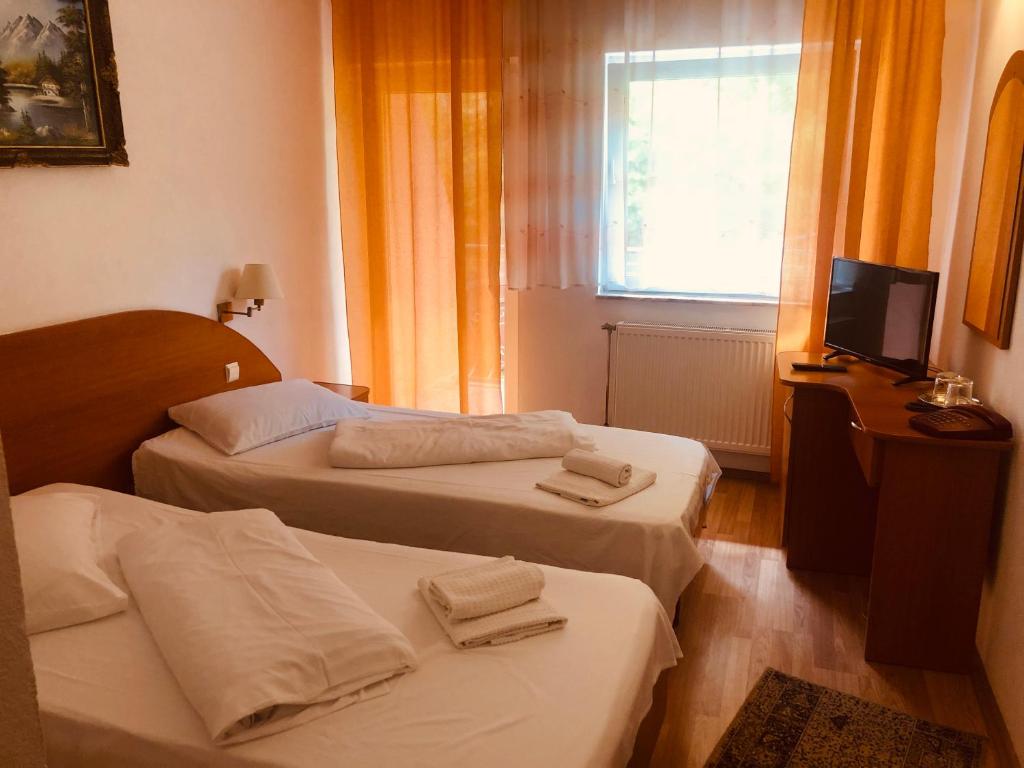 Postel nebo postele na pokoji v ubytování Hotel Poenita