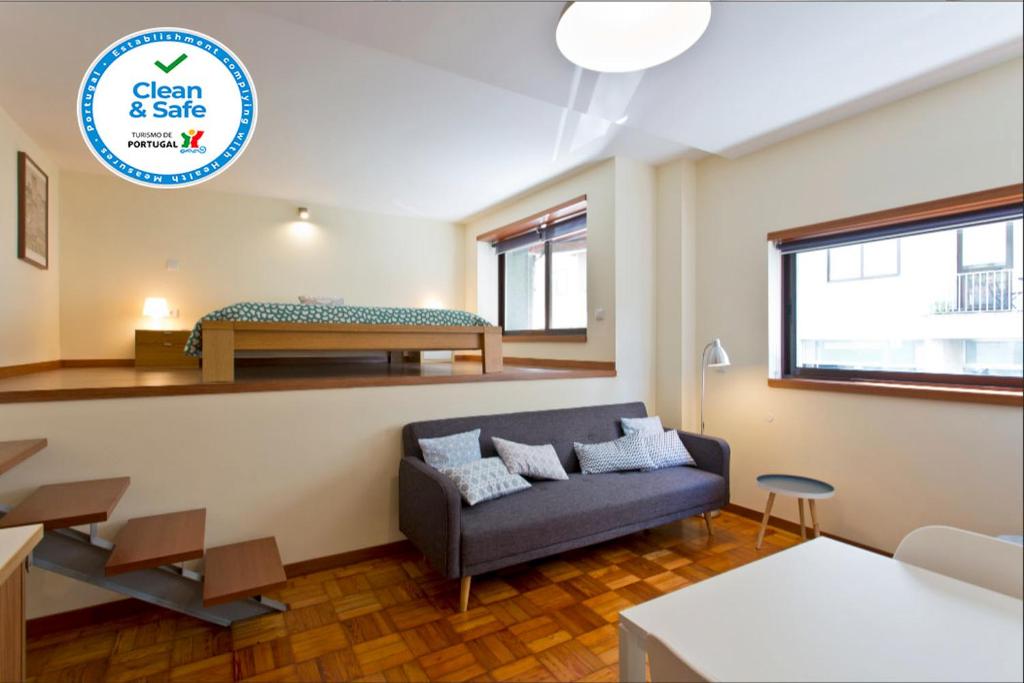 a living room with a couch and a bed at Studio 312 - With Free Parking in Porto