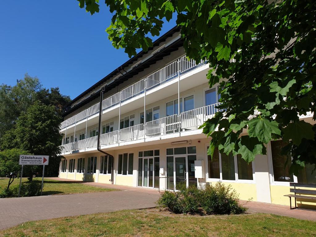 a large white building with a bench in front of it at Gästehaus Haßloch/Pfalz in Haßloch