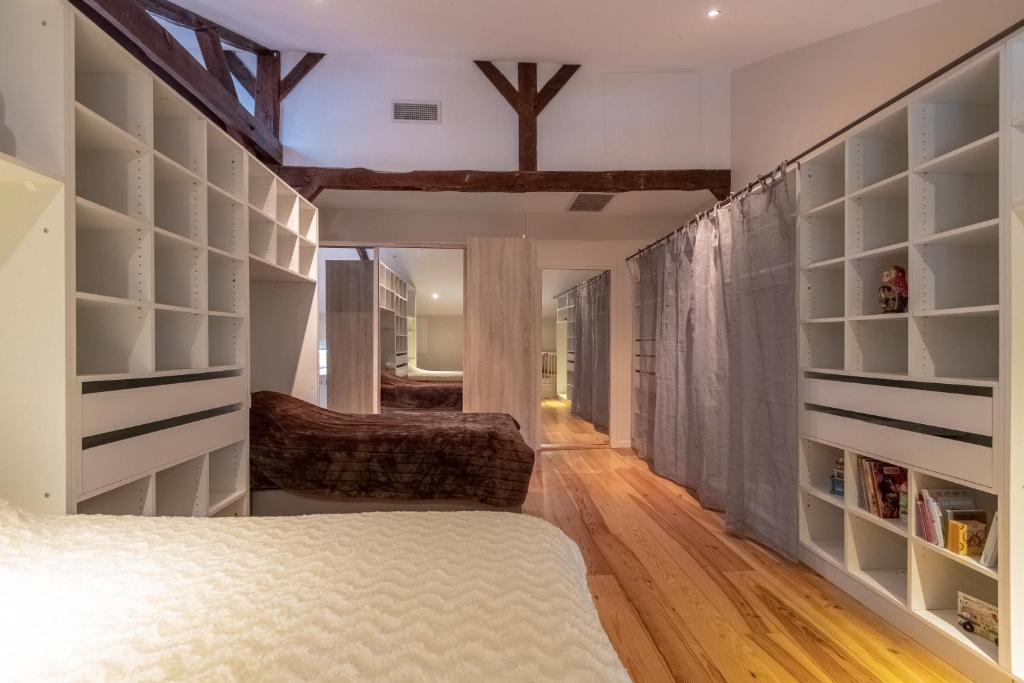a bedroom with a bed and book shelves at Othil in Aire-sur-lʼAdour
